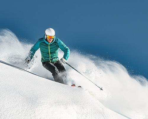 Person skiing under a blue sky. 